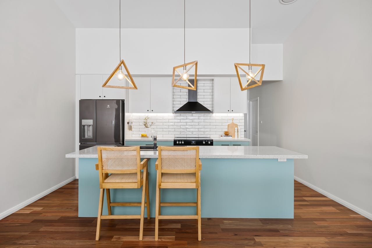 Finished kitchen remodel in Lafayette, CA with eggshell blue island and modern pendant lights