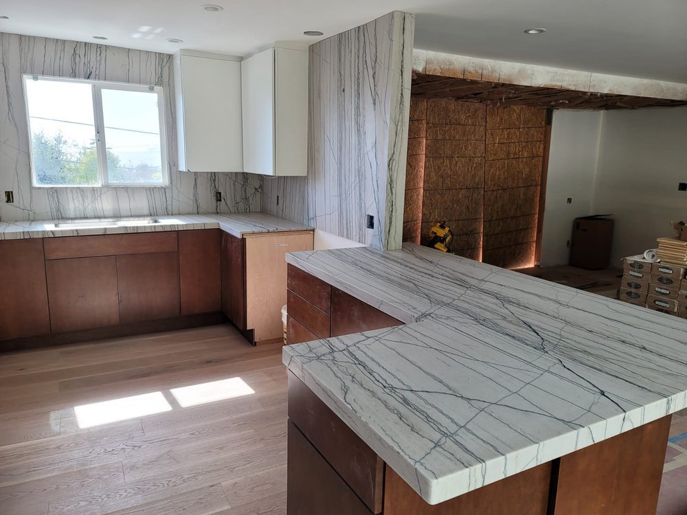 Sleek modern kitchen with streaky granite countertops