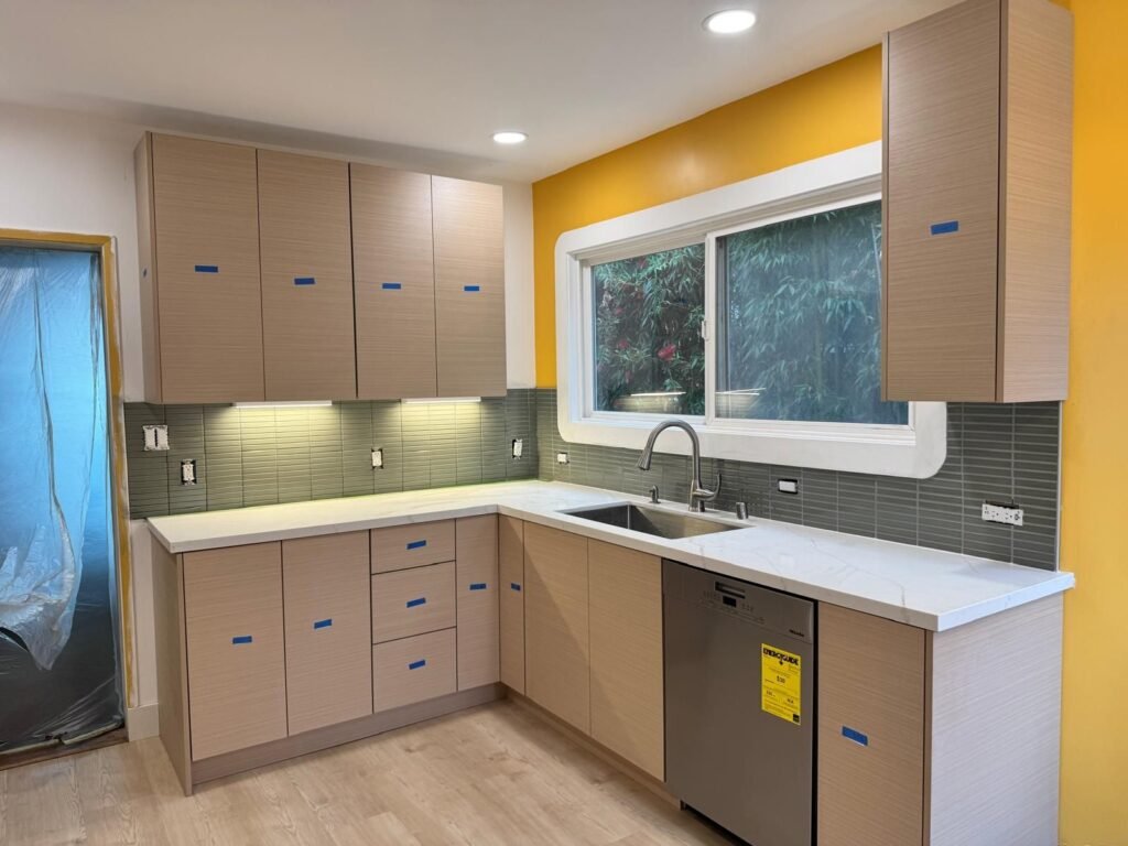Kitchen remodel with modern cabinets and green tilework